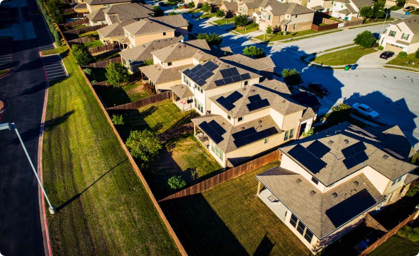 A row of houses share a single wooden fence.