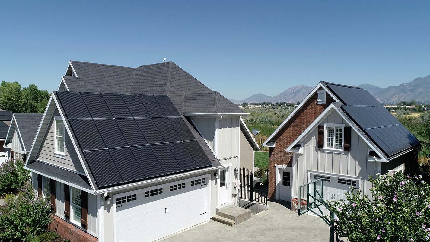 A home with a stand alone garage both have solar panels.