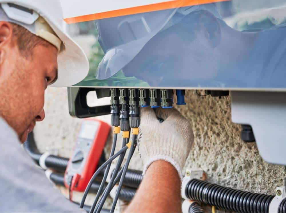 Man working with electrical plugs