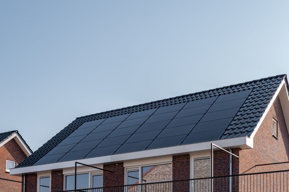 A roof with black solar panels.